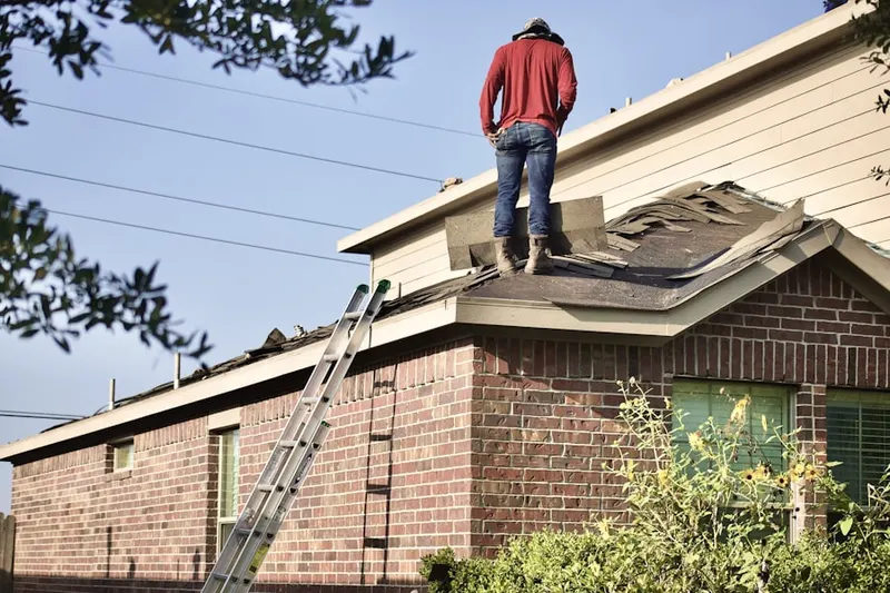 Professional roofer working on a residential roof in Crane Square